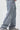 Light blue jeans with cross patterns on a white background