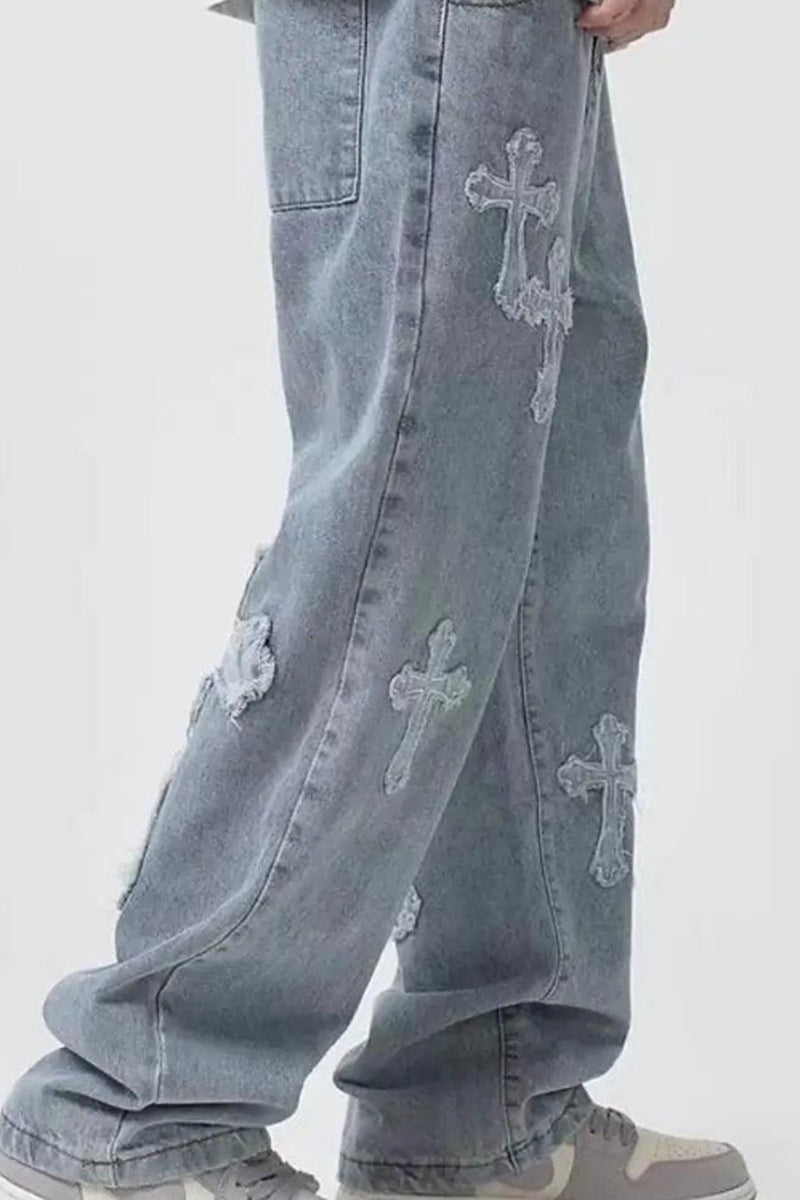 Light blue jeans with cross patterns on a white background