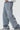 Light blue jeans with decorative elements on a white background