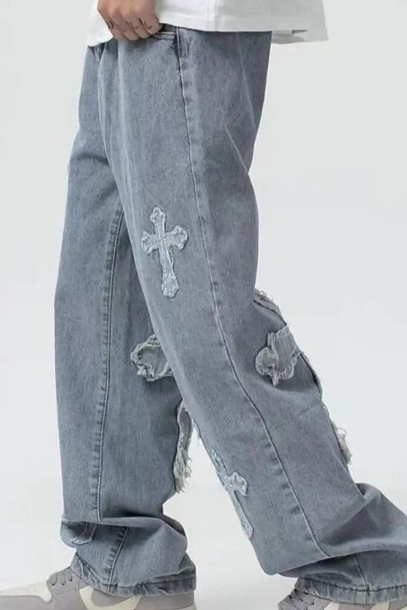 Light blue jeans with decorative elements on a white background