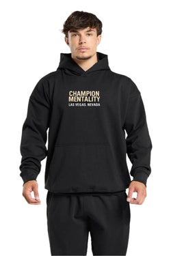 Black hoodie featuring 'Champion Mentality' on the front, designed for comfort and style.
