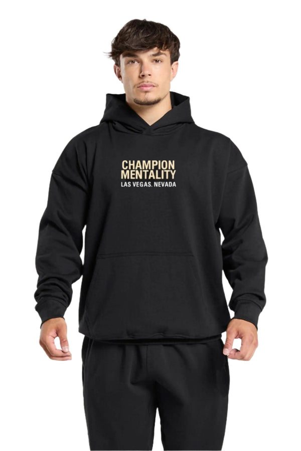 Black hoodie featuring 'Champion Mentality' on the front, designed for comfort and style.
