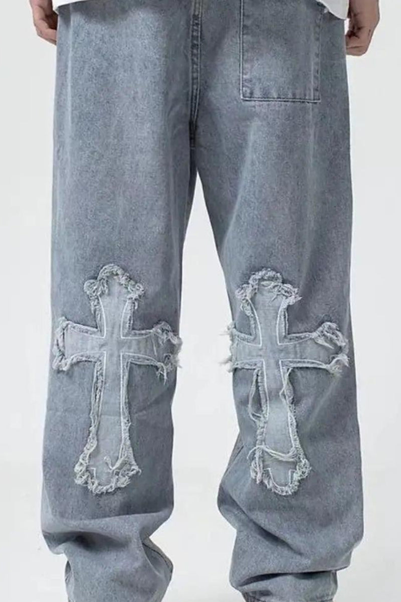 Gray jeans with cross designs on a white background