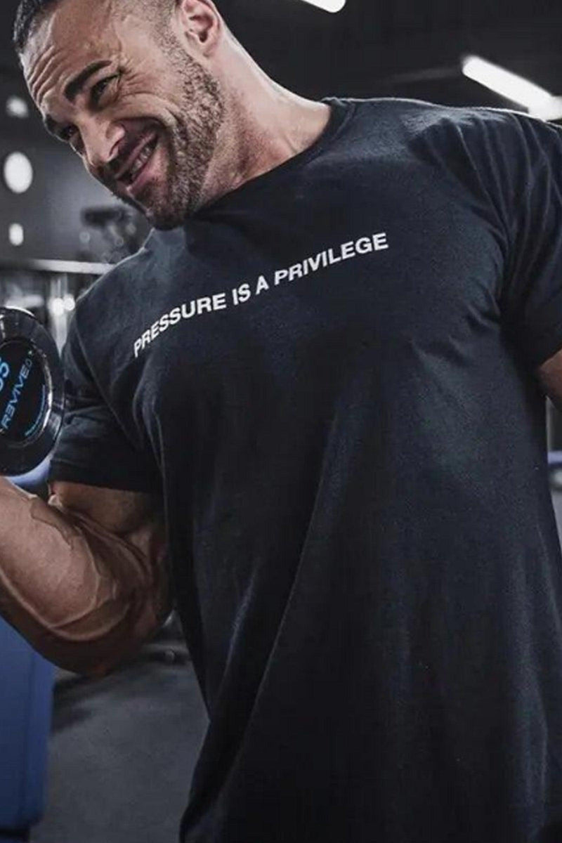 Pump cover with 'Pressure is a Privilege' text, featuring an oversized fit for comfort and style during workouts.