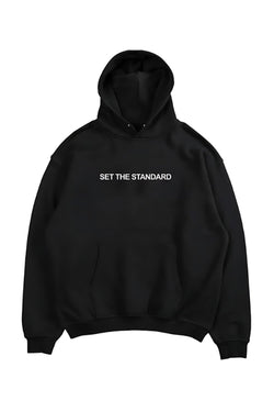 Oversized hoodie featuring 'Set the Standard' text, designed for comfort and style with a relaxed fit and adjustable drawstring hood.