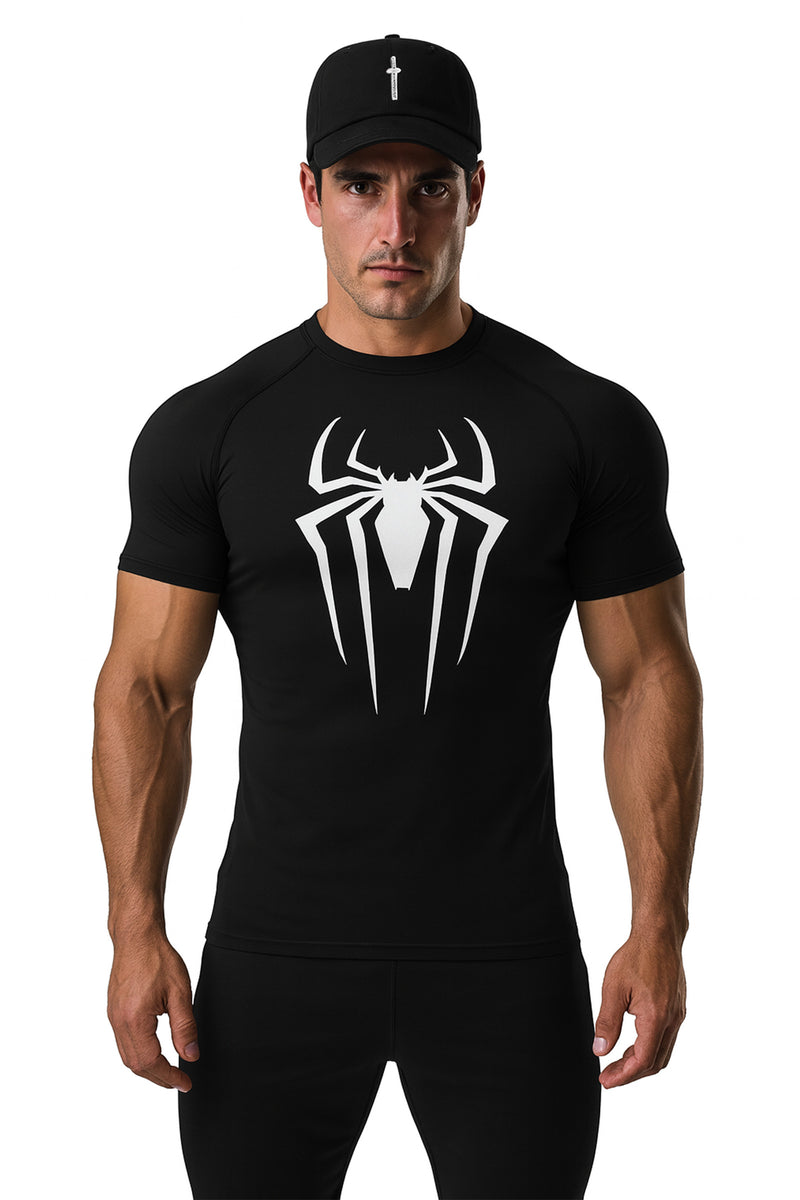 Man wearing a black t-shirt with a white spider logo and a black cap on a white background