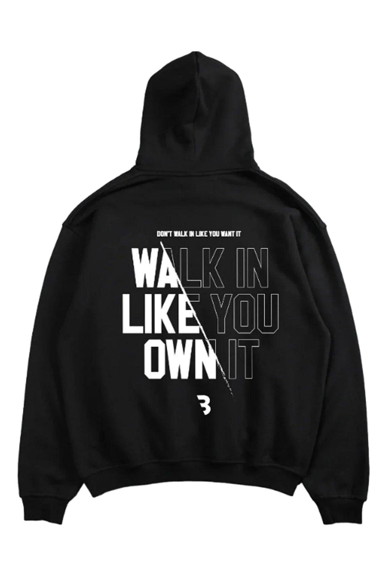 Oversized hoodie with 'Walk Like You Own It' text, designed for comfort and style with a relaxed fit and adjustable drawstring hood.